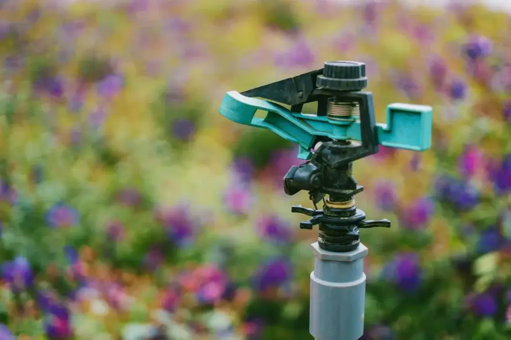 Impact sprinkler head watering flower bed